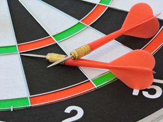 Dart arrow hitting in the target center of dartboard. Success hitting target aim goal achievement...