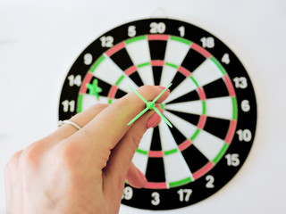 Dart arrow hitting in the target center of dartboard. Success hitting target aim goal achievement...