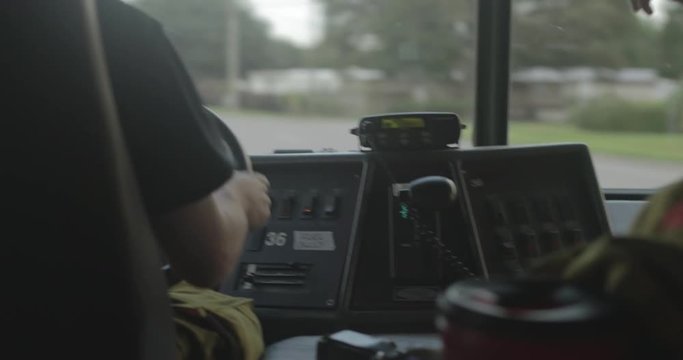 Firefighter radio inside driving firetruck