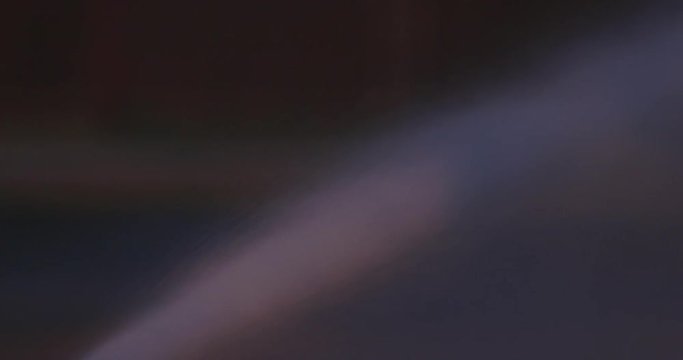 Water sprays from a firehose at night