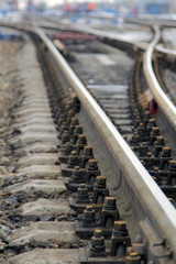 Railway. Rails and sleepers close-up. Blurred background.