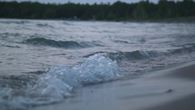 Footage of slow motion waves crashing on a beach.
