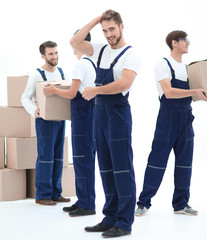 Obraz premium The team of responsible movers and their smiling leader,