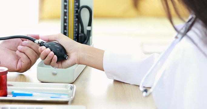 Close up scene video of doctor using Mercury sphygmomanometer to checking patient's blood pressure in hospital, concept for checking blood pressure in hospital.