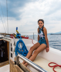 Obraz premium Young teen sitting on a sailboat
