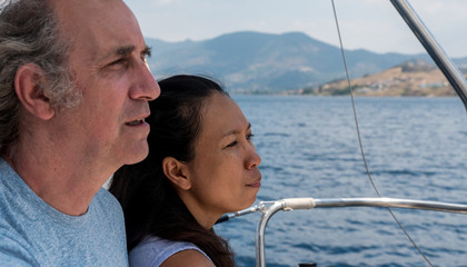 Closeup of man and woman in the cockpit of a sailboat