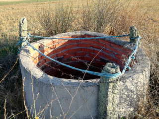 Well of water for the irrigation of the field of the center of the Iberian Peninsula. Irrigation system from shallow underground aquifer. The agricultural industry of Europe.