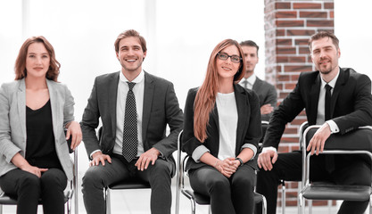 Group of attractive laughing businesspeople talking and joking sitting