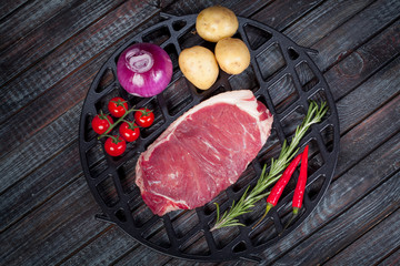 beautiful and juicy raw steak on the table with ingredients ready to roast