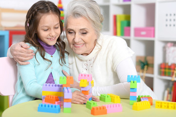 Portrait of cute girl and grandmother playing