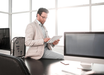 businessman with digital tablet sitting on office Desk.