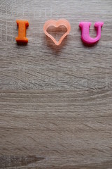 'i love u' word Close-up shot selective focus colorful, magnetic letters with romantic question for Valentine's Day
