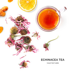 Creative layout made of cup of hot tea with echinacea and lemon on a white background. Top view.