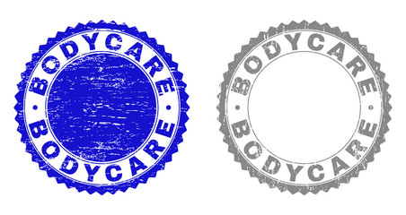 Grunge BODYCARE stamp seals isolated on a white background. Rosette seals with grunge texture in blue and gray colors. Vector rubber imitation of BODYCARE caption inside round rosette.