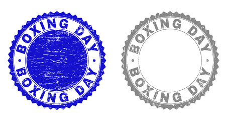 Grunge BOXING DAY stamp seals isolated on a white background. Rosette seals with distress texture in blue and grey colors. Vector rubber watermark of BOXING DAY text inside round rosette.