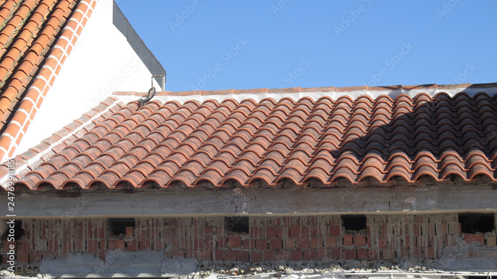 Wall mural winter sun shining on newly refurbished roof in andalusian village