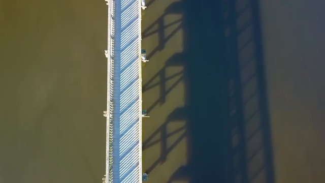 Spectacular top down aerial drone view of boardwalk in-between a lake in Oso Flaco, located on the Central Coast of California, Santa Barbara County