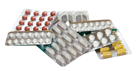 Set of multicolor pills in white blister packs