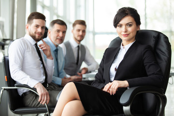 business woman with her staff, people group in background at modern bright office indoors