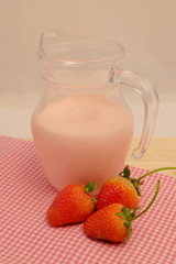 Strawberry and milk straberry flavoron wood table, sweet romantic fruit for special person in special days, lovers in Valentine day, make many dessert menu or juice or dairy strawberry flavor