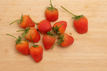 Strawberry on wood table and space for write wording, sweet romantic fruit for special person in special days, lovers in Valentine day, make many dessert menu or juice or dairy strawberry flavor