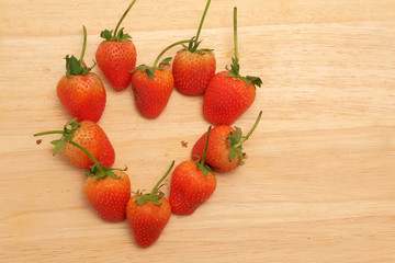 Strawberry on wood table and space for write wording, sweet romantic fruit for special person in special days, lovers in Valentine day, make many dessert menu or juice or dairy strawberry flavor