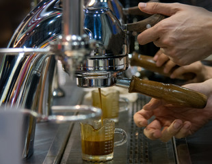 Espresso shot from coffee machine in coffee shop,Coffee maker in coffee shop