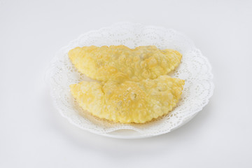 Chebureki on the plate isolated on white