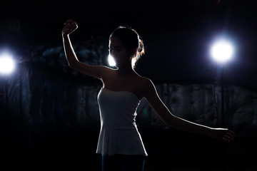 Asian Tan Skin Fitness woman exercise Stretch arms legs warm up Smoke Dark background environment,...