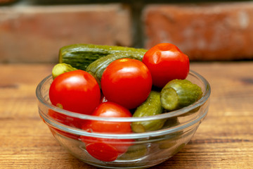 Pickles in the glass jar on the wooden table