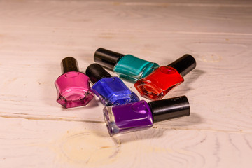 Different nail polishes on a wooden table