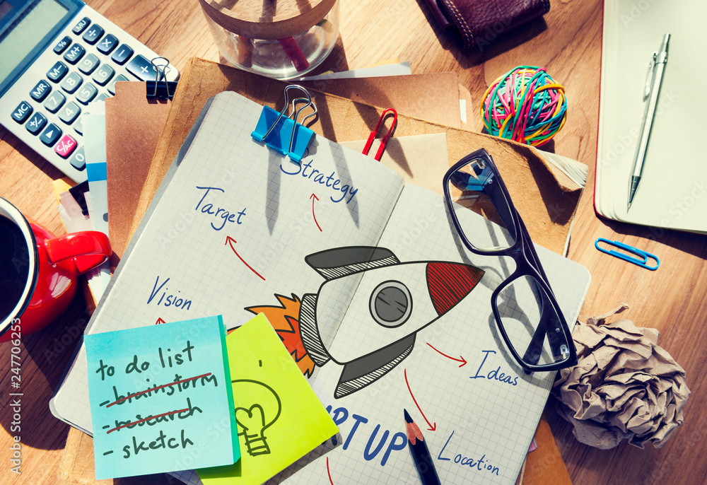Wall mural rocket drawn in a notebook on a messy table