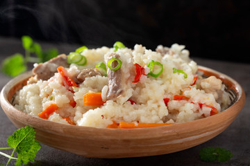 Pilaf stew made from rice, chicken meat, carrot and onion