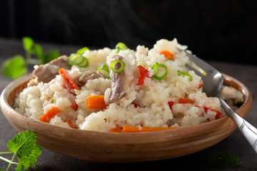Pilaf stew made from rice, chicken meat, carrot and onion
