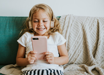 Little girl watching cartoons on her phone