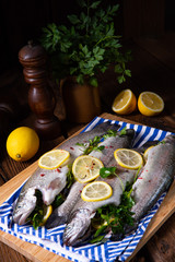 Fototapeta na wymiar fresh trout with lemon and different herbs