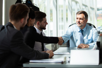 Business people shaking hands, finishing up a meeting.