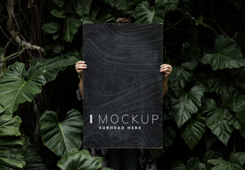 Female in a tropical background holding a signboard mockup