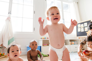 Cheerful babies in the play room