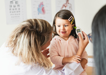 Otolaryngologist checking up on a sweet little girl