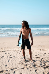 Surfer man with surf board on the beach. Mixed race black skin and beard. Summer sport activity