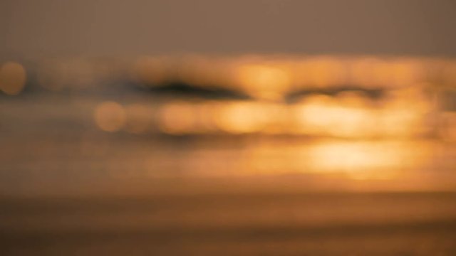 Blurred and bokeh background of sea wave on twilight