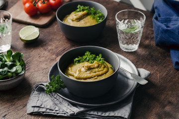 Split Pea Soup with Vegetables on a wooden background, selected focus