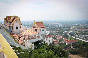 Fototapeta na wymiar The view from the observation platform of the Buddhist monastery, the observation deck on the city Prachuap Khiri Khan in Thailand in the afternoon. Buddhist monastery on top of the mountain