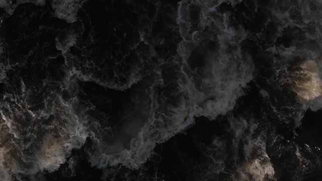 Top Down view fast moving river (Nykopingsan). Nykoping, Sweden. Aerial in slowmotion. Close up