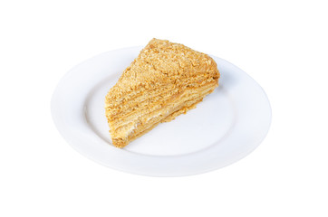 piece of honey cake on a white plate isolated on white background