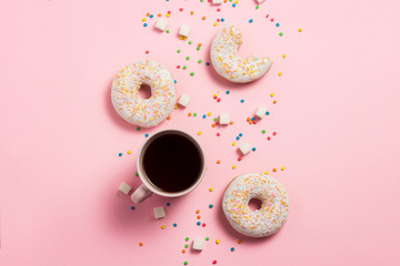 Cup of coffee, Fresh tasty sweet donuts on a pink background. The concept of fast food, bakery, breakfast, sweets. Minimalism. Flat lay, top view, copy space.