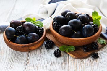 Bowls with fresh plums