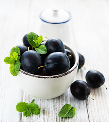 Bowl with fresh plums