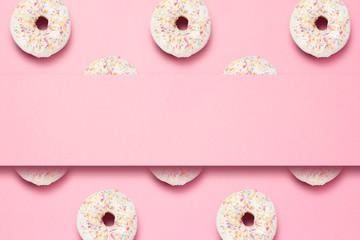 Fototapeta na wymiar Fresh tasty sweet donuts on a pink background. Place for text. The concept of fast food, bakery, breakfast, sweets. Minimalism. Pattern. Flat lay, top view, copy space.